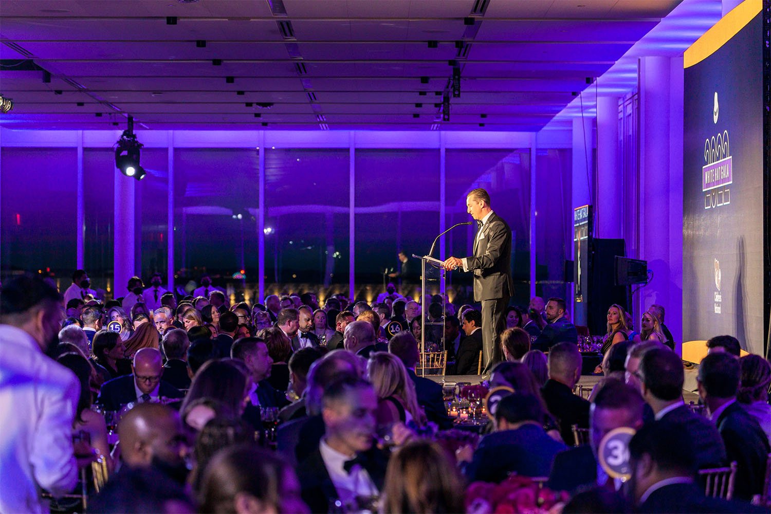 Speaker at podium talking to gala attendees