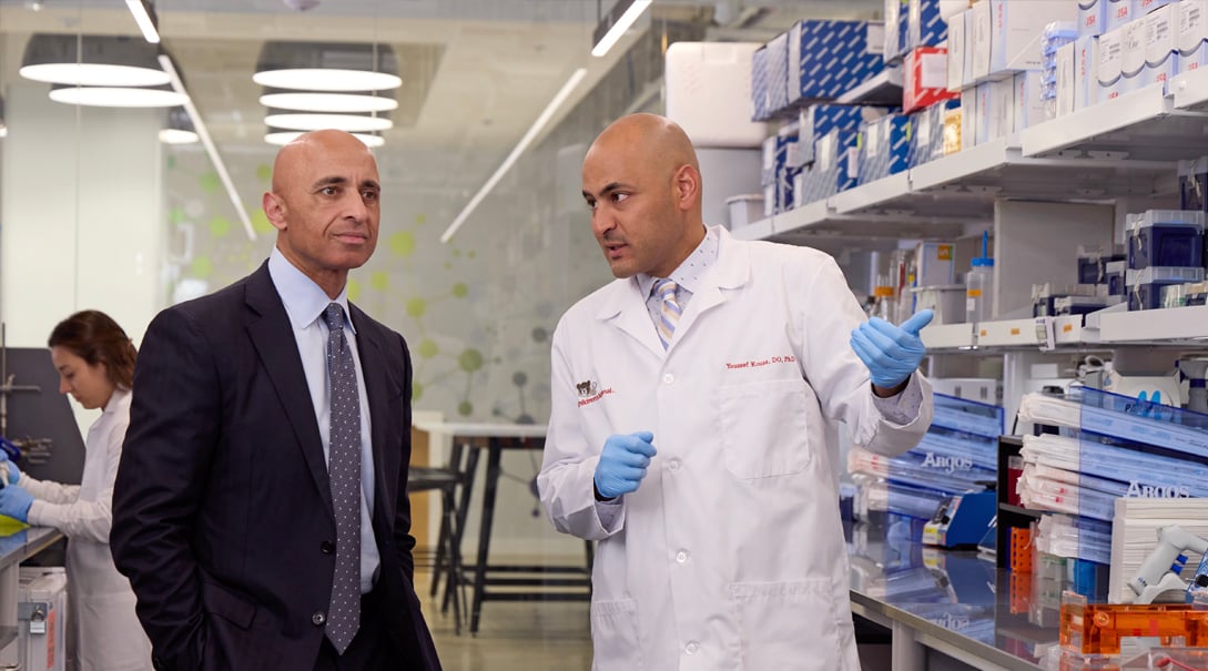 Two male doctors confer in a research lab.