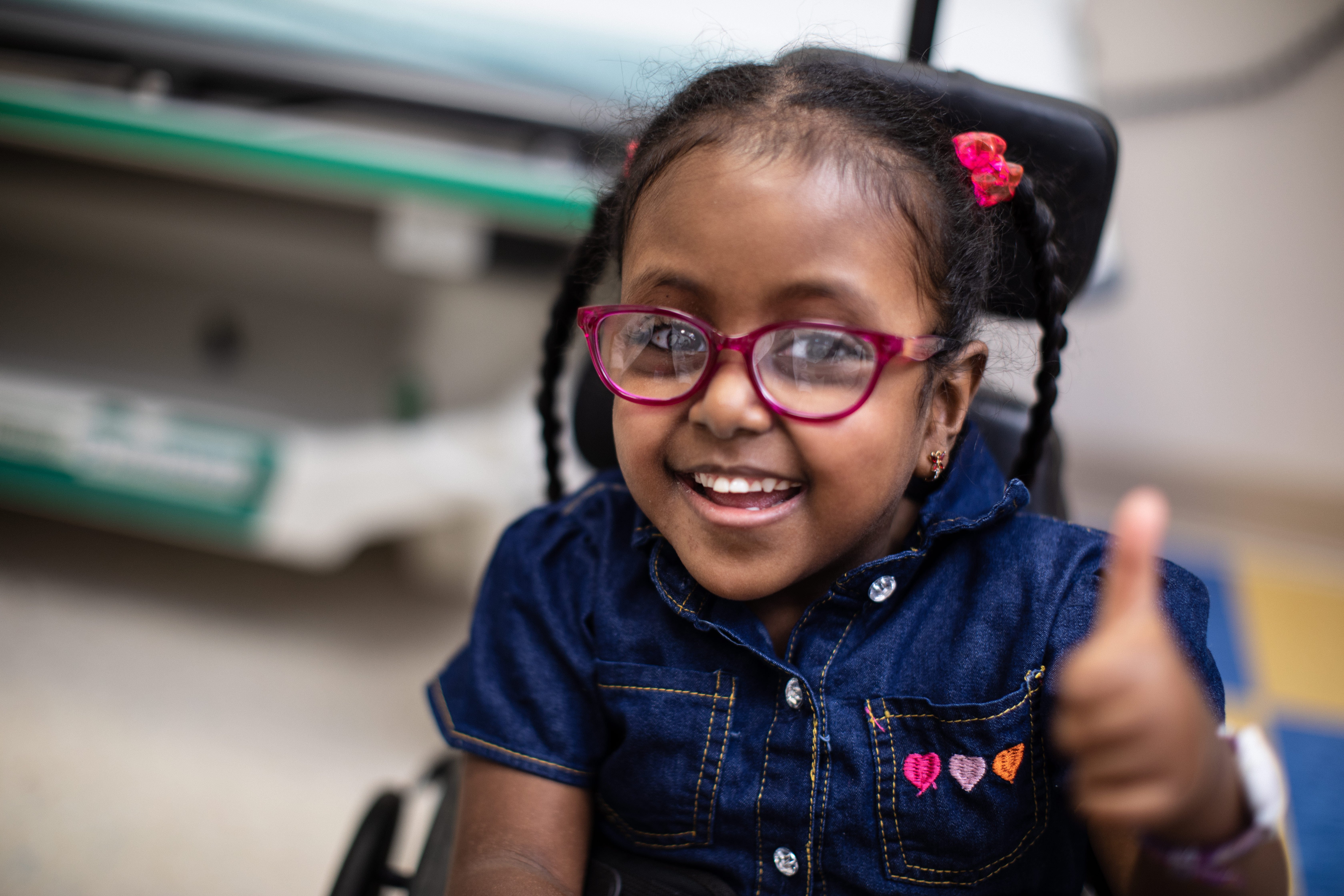 Photo of Black elementary school aged female patient smiling.