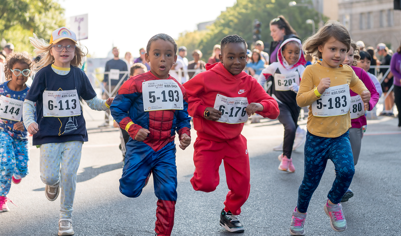 Children dressed as super heroes participate in the Kids Dash event.