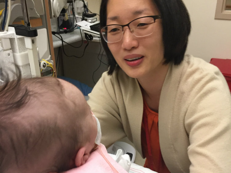 Dr. Chang sits with baby Bella