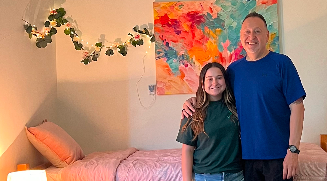 Ariana stands with her father.