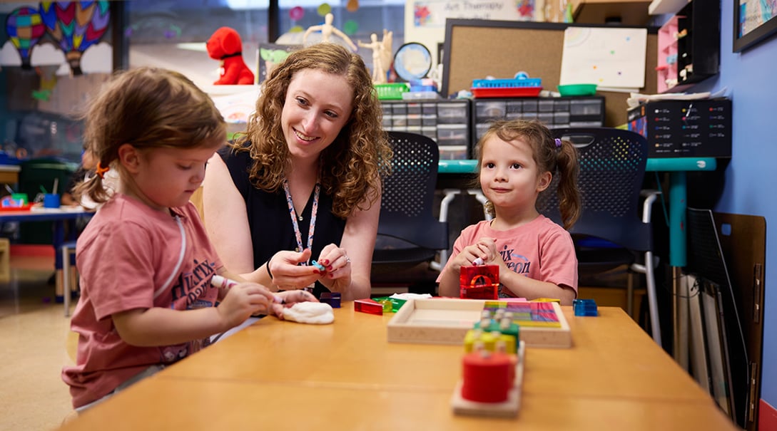 Lauren Schlenger, MA, ATR-BC, LPC, art therapist, with patients in the Tracy's Kids art therapy studio.