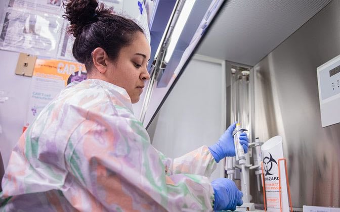 A researcher conducts genetic experiments in a lab.