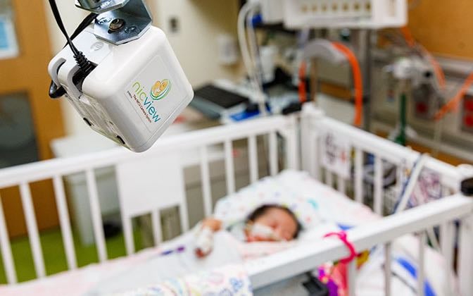 A video camera pointed at a newborn patient allows family to see the baby in their crib in the unit.
