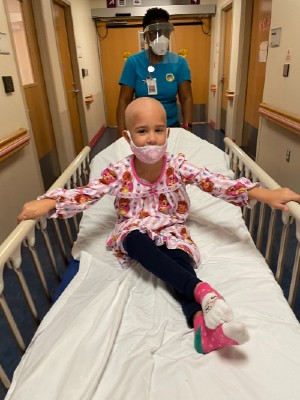 Isabel sitting on a hospital bed