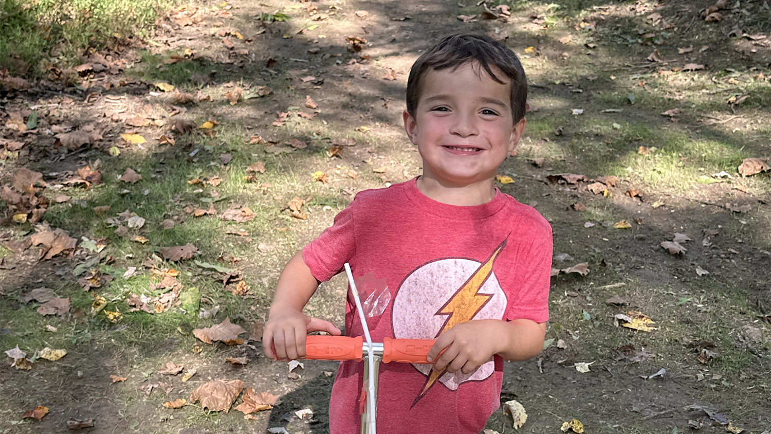 John outside on a scooter