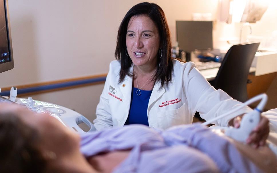 Dr. Mary T. Donofrio uses ultrasound to examine a pregnant woman's baby in utero.