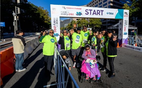 A family team poses for a group photo at the starting line at a Race for Every Child.