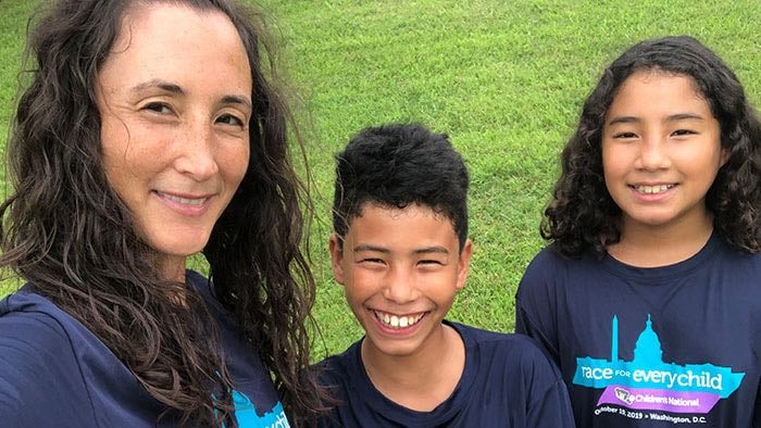 A selfie photo of a mother and her two children during the Race for Every Child event.