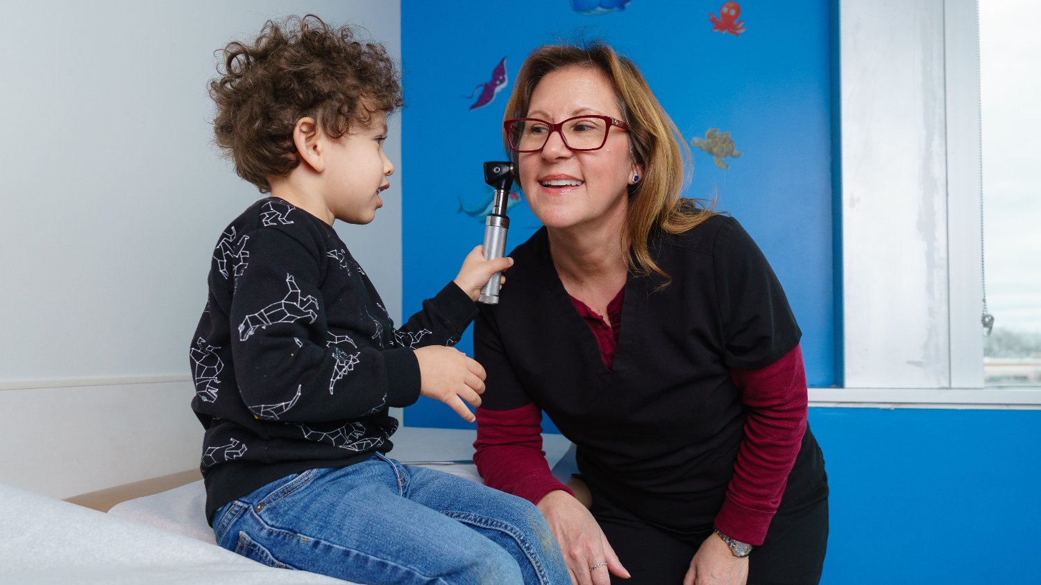 child examines doctors ear