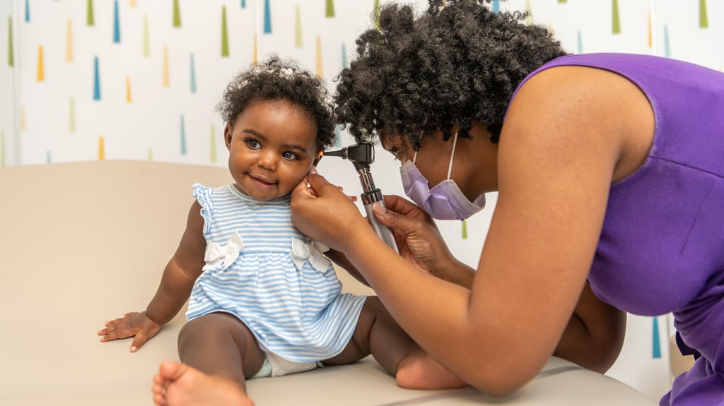 doctor examines baby's ear