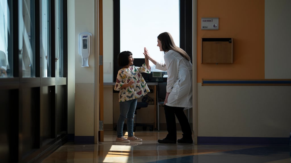 doctor high fives young patient