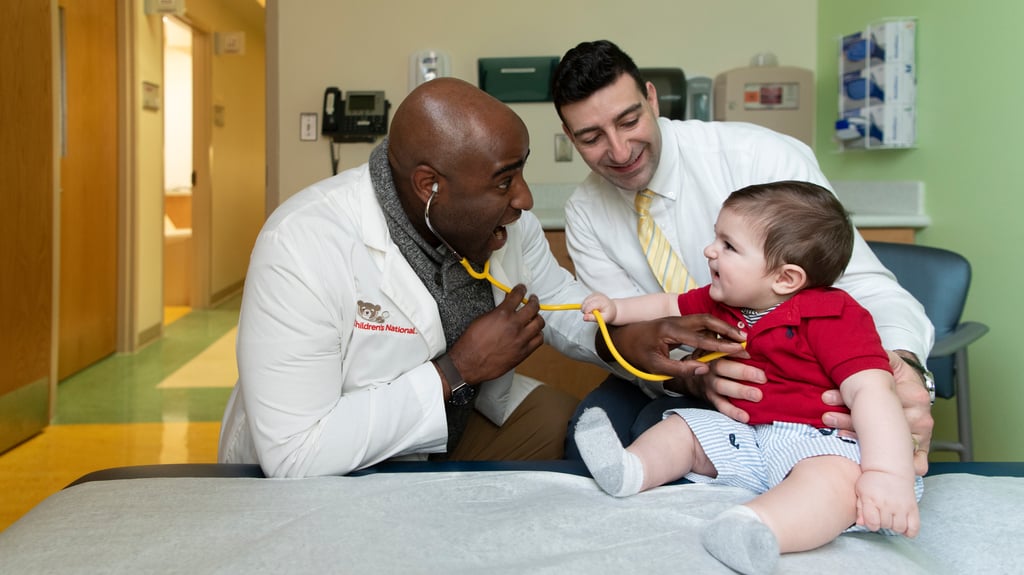 doctor listens to baby's chest with stethoscope