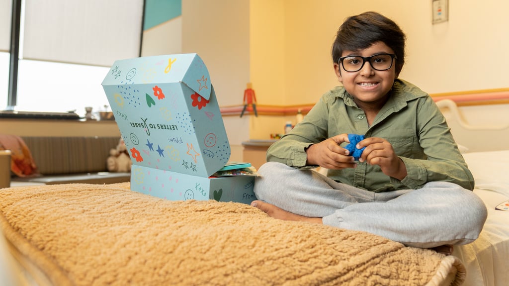 smiling boy next to gift box