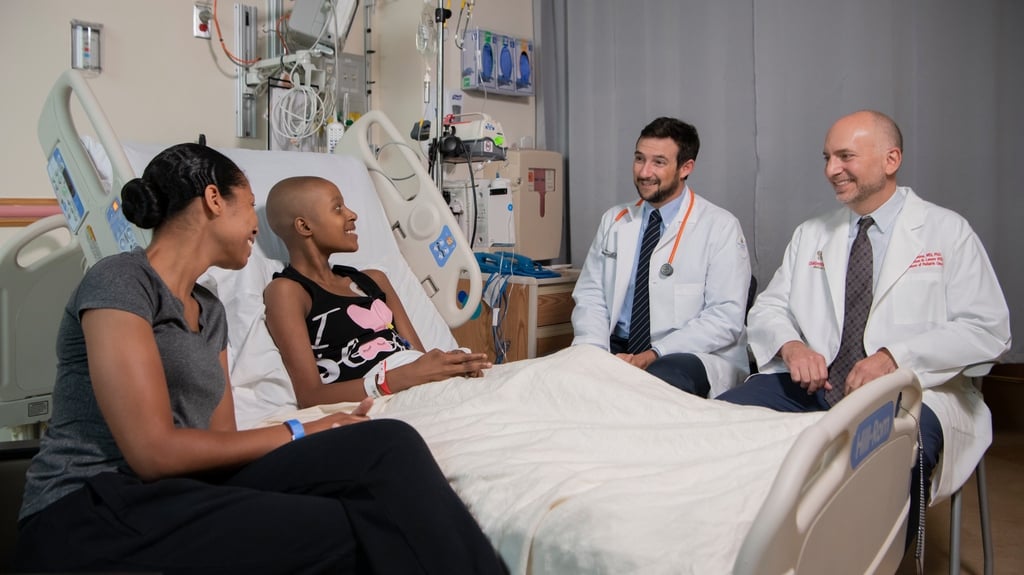 hospital room with oncology patient and doctors