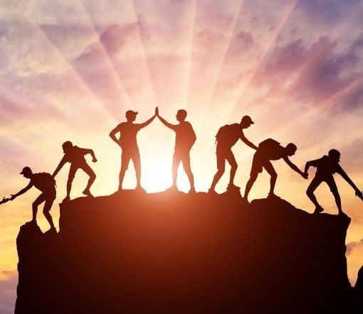 teamwork climbing a mountain
