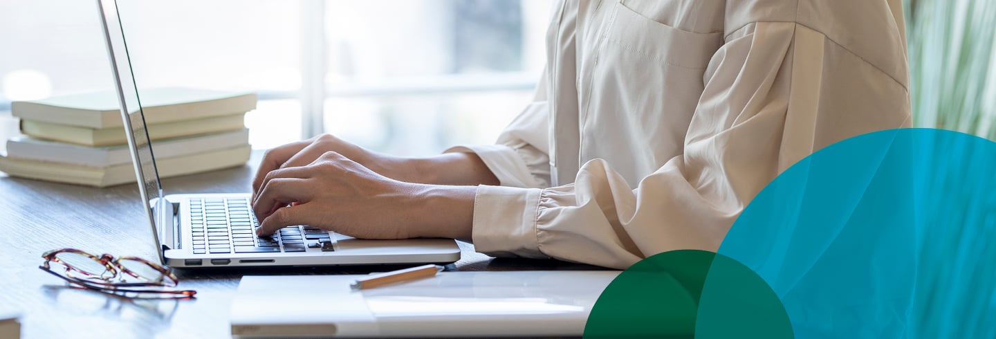 Person sitting at a desk and working on a computer