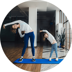 Mother and daughter do yoga together