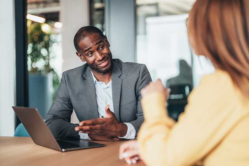 A man and a woman in a meeting.