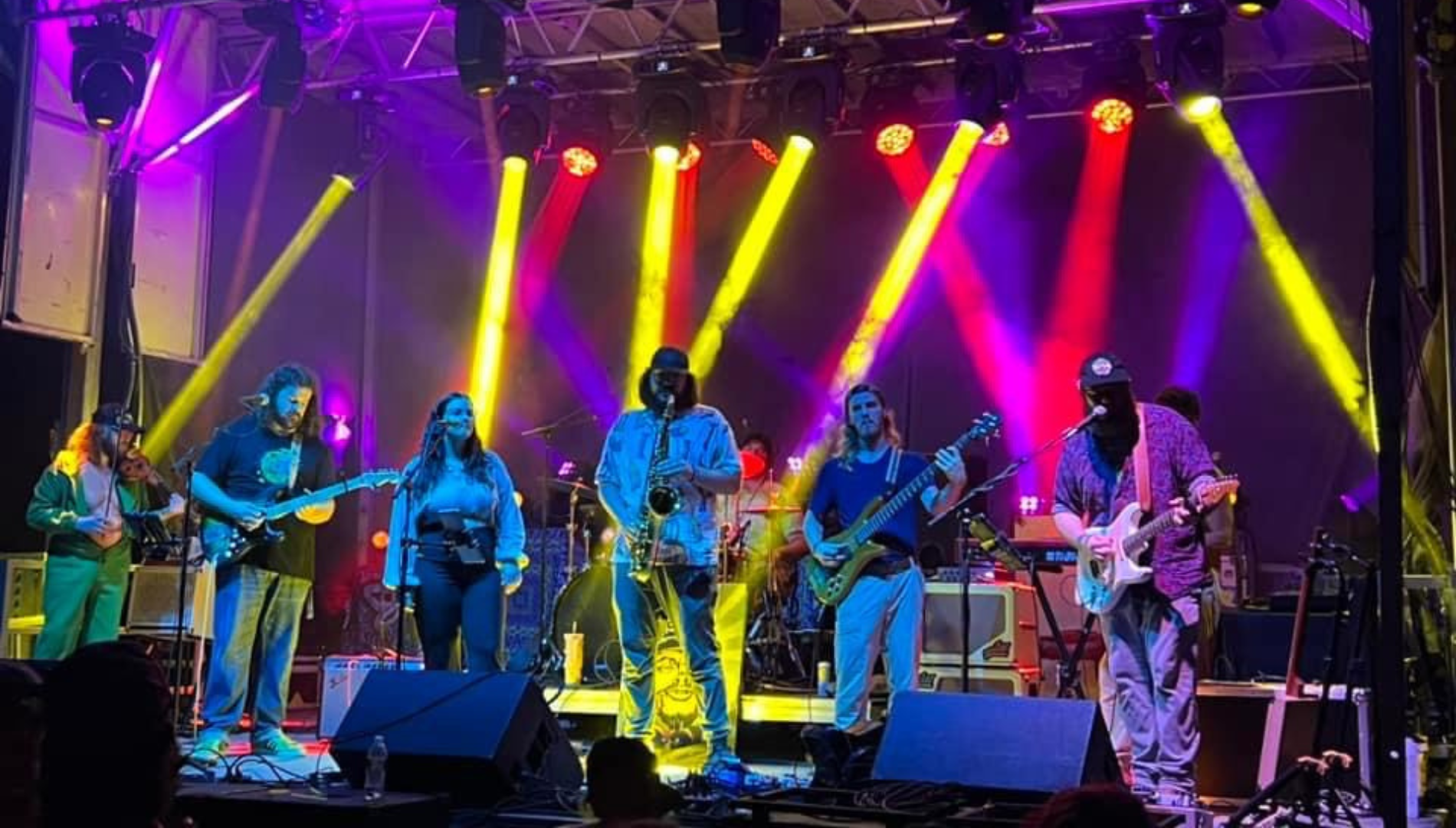 Artists performing on stage with lights