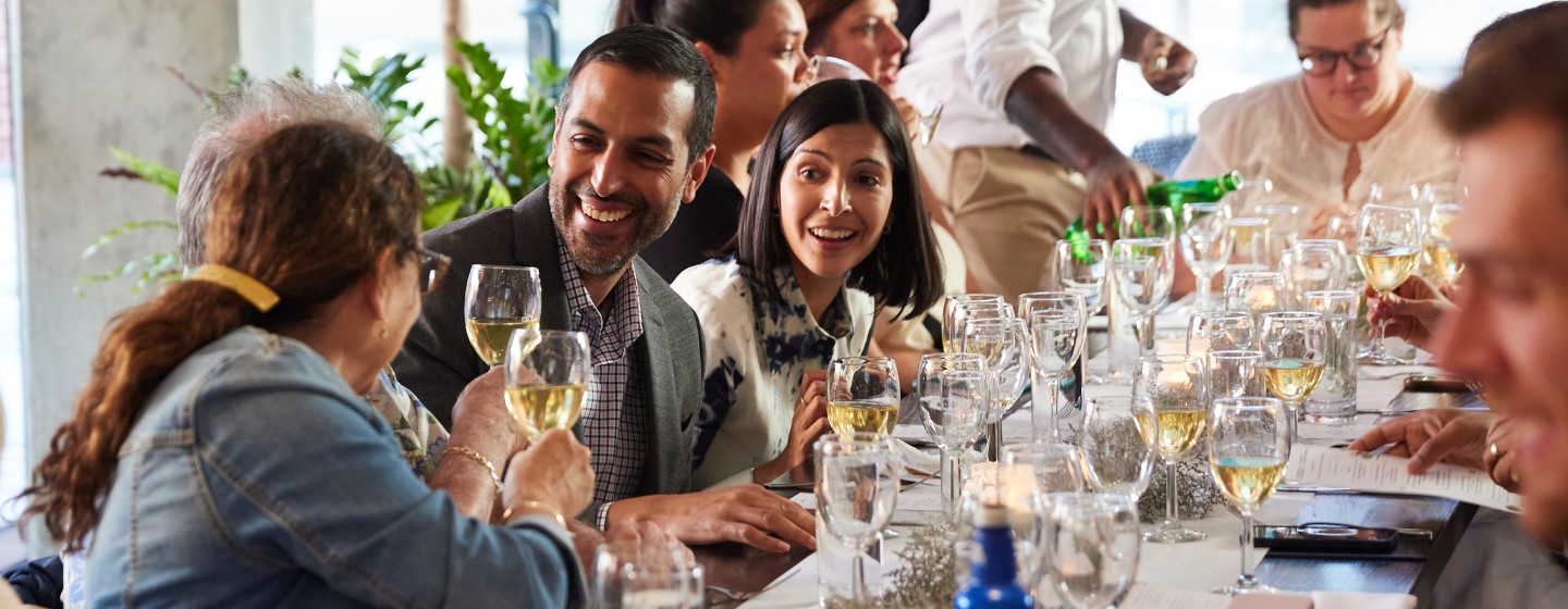 Group of people at a wine dinner at Katie's Pizza & Pasta Osteria.