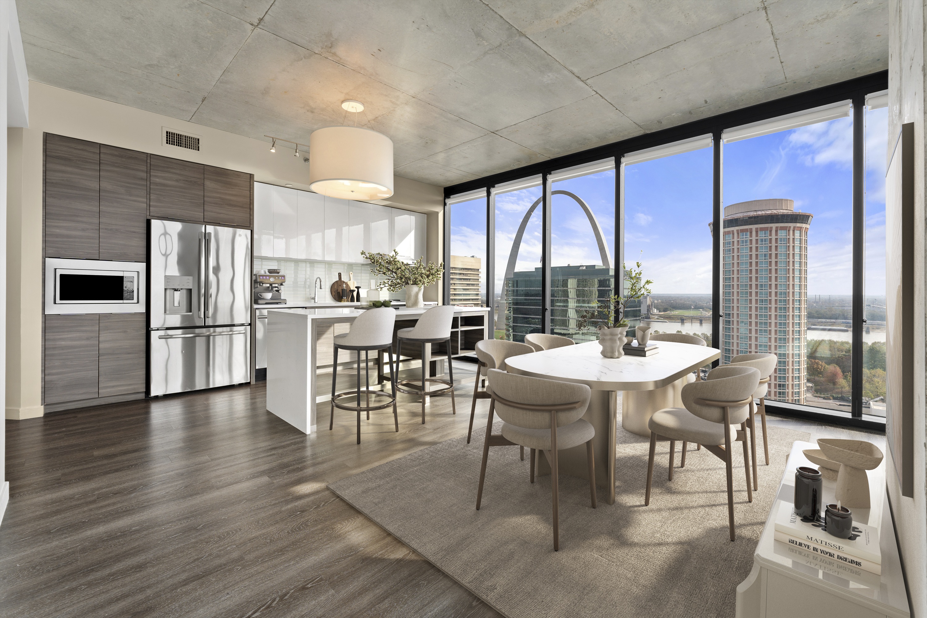 Modern apartment dining room and living area with floor to ceiling windows at One Cardinal Way