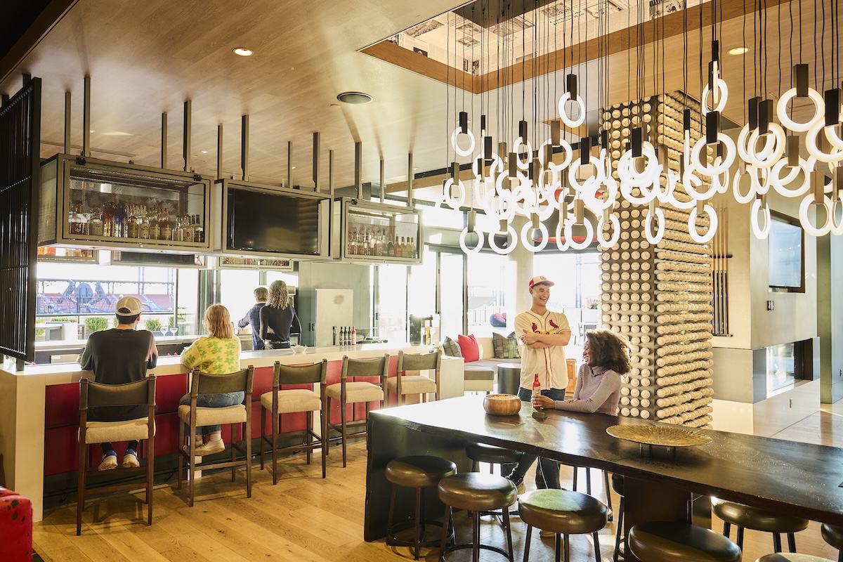 Residents enjoying happy hour at the bar of One Cardinal Way