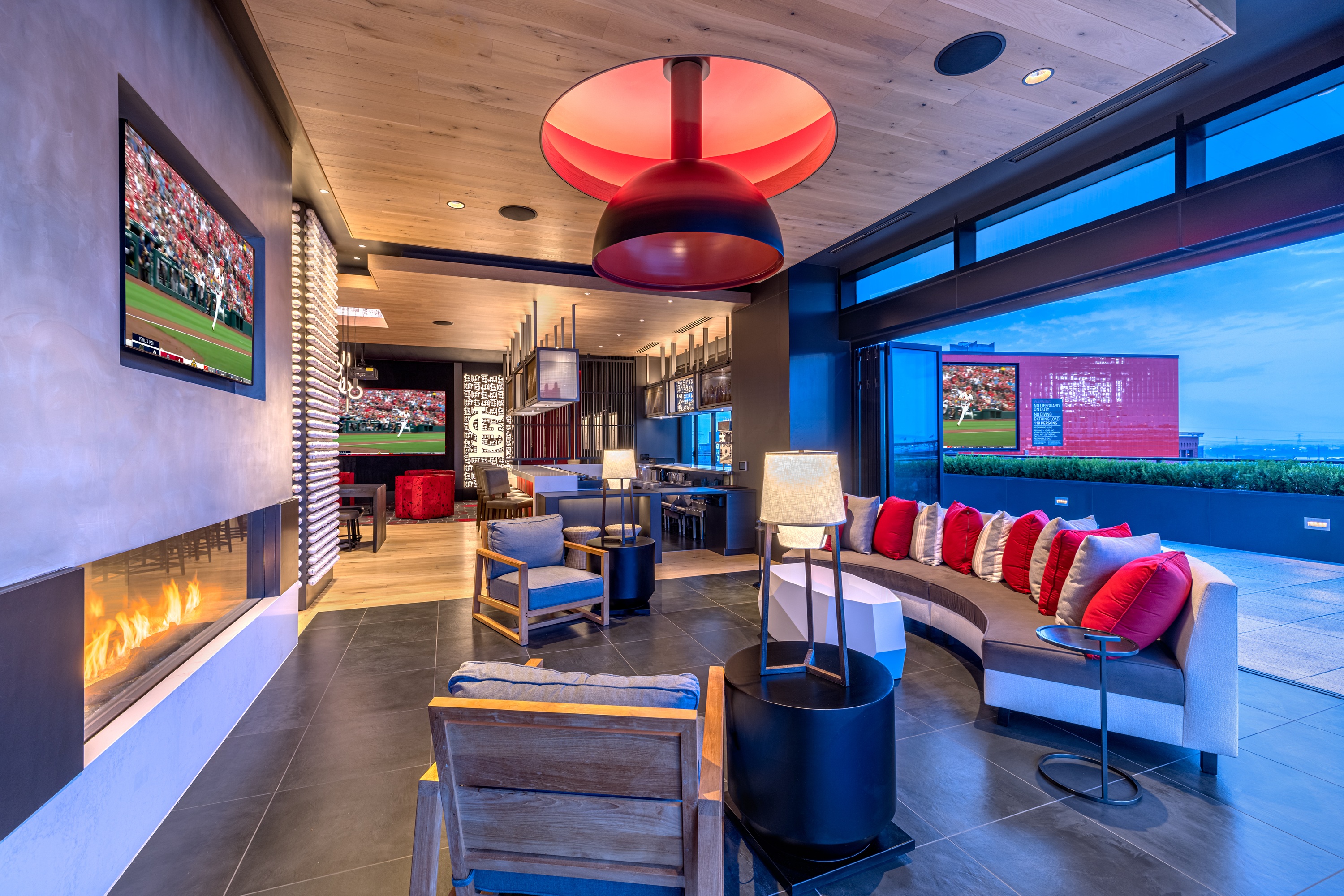 Modern Indoor-outdoor bar with multiple TVs and comfortable sitting lounge area