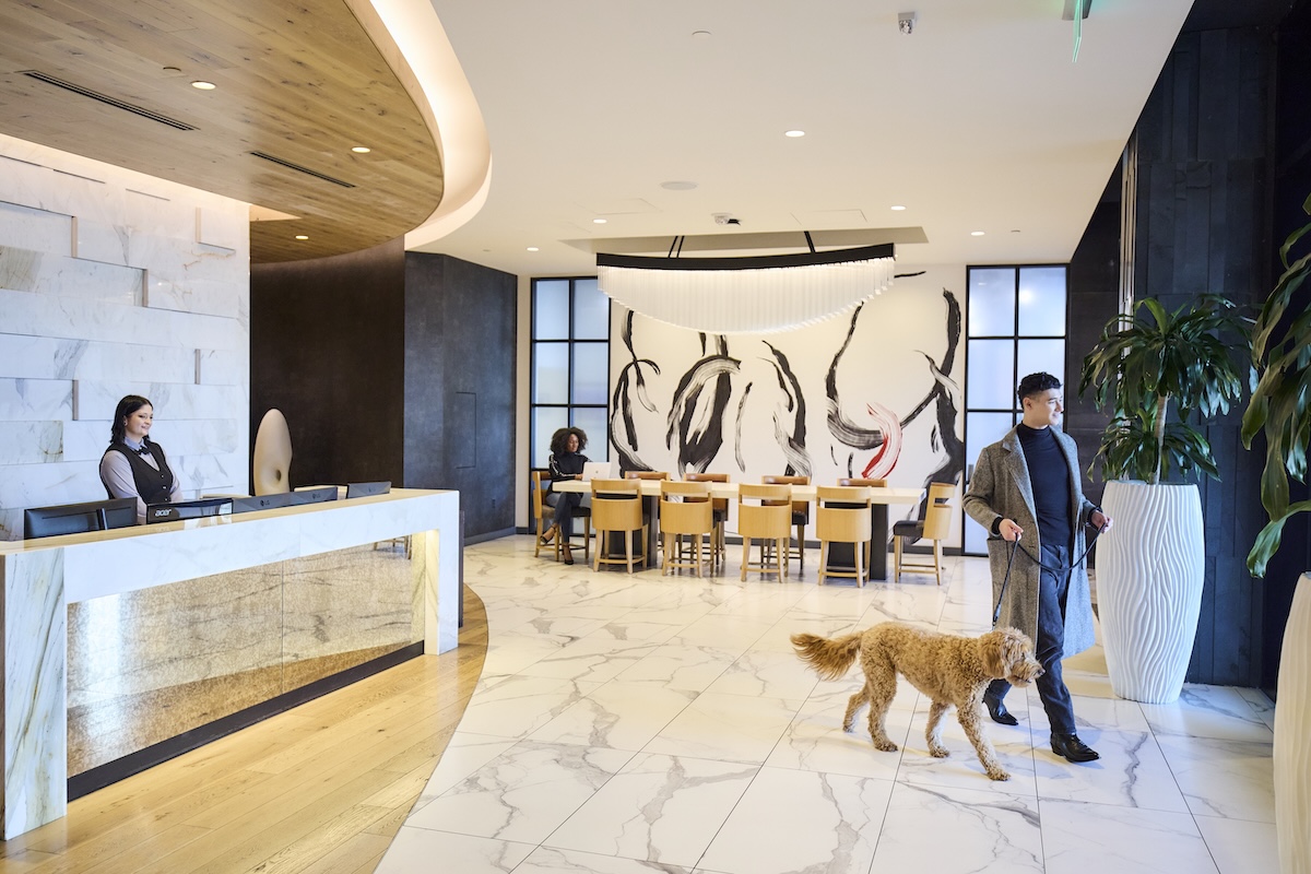 Resident walking his dog in modern lobby
