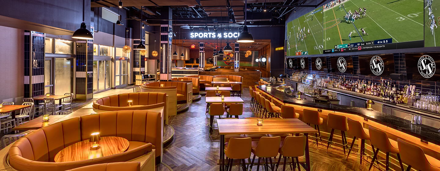 Architectural image of Sports and Social showing dining and bar seating, as well as LED screen.