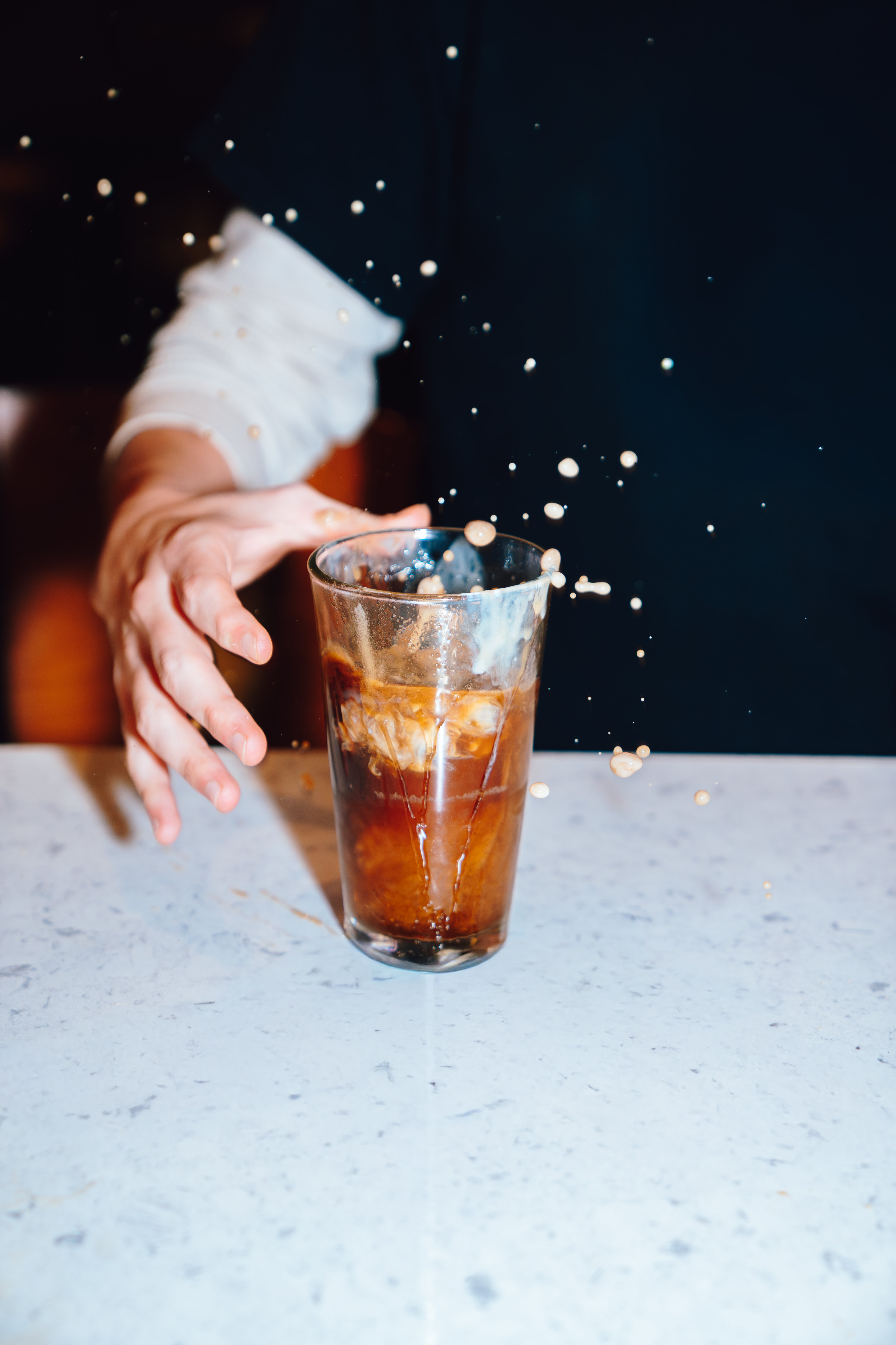 An image of a shot being dropped into a Jager Bomb.