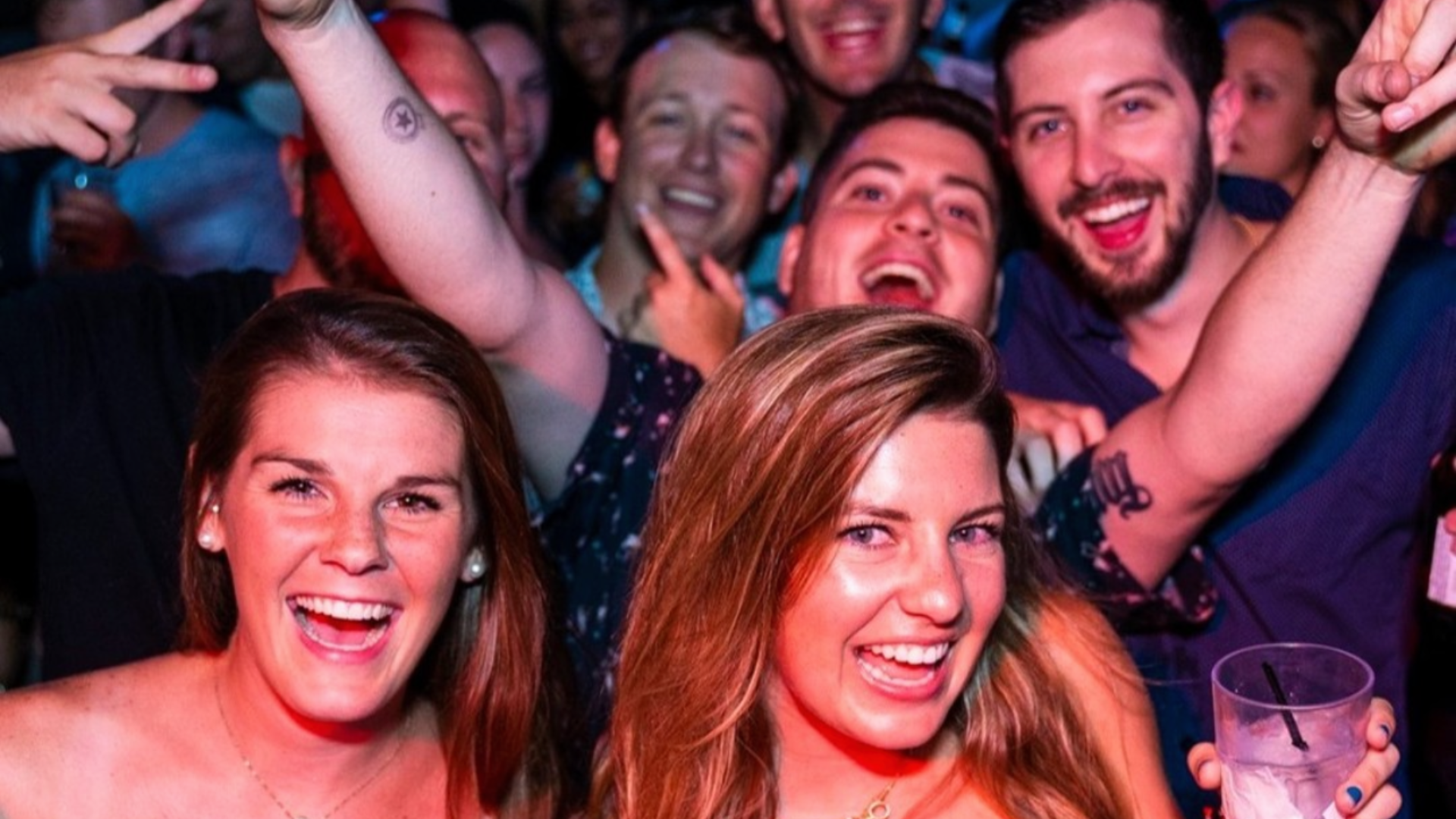 An image of 2 women and 3 men partying at Howl at the Moon.