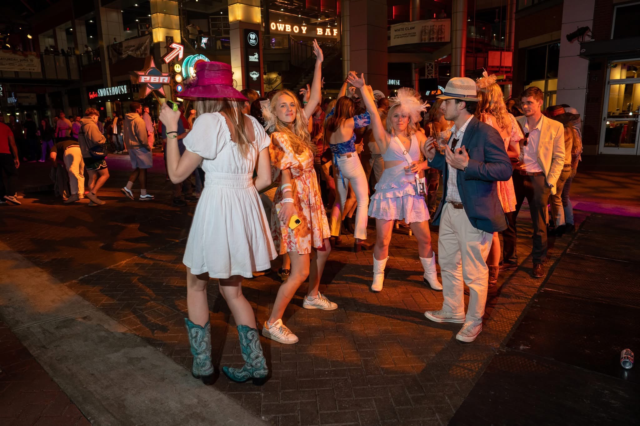An image of people dancing in their Derby outfits.