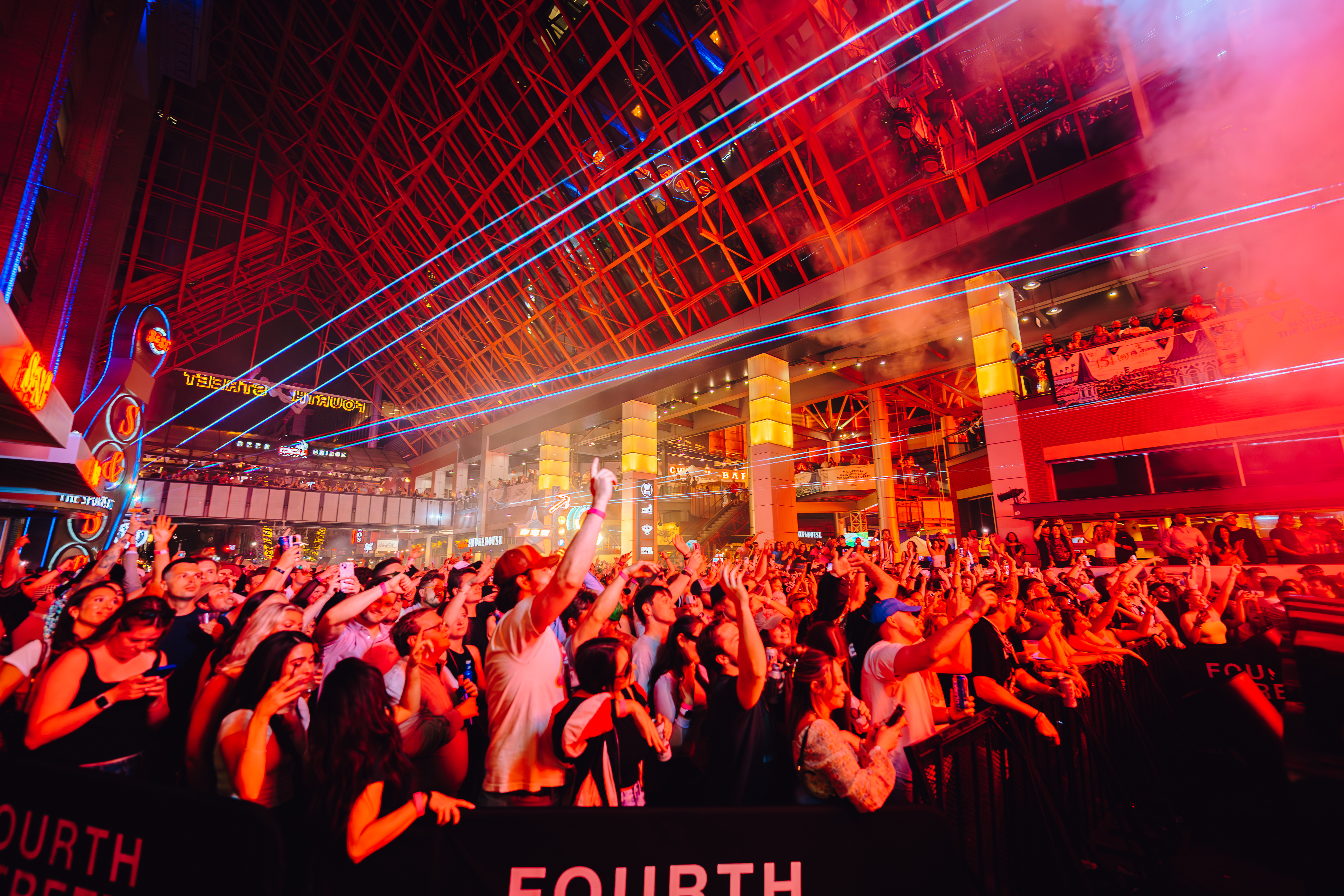 An image of a packed crowd at a concert and layers above them.
