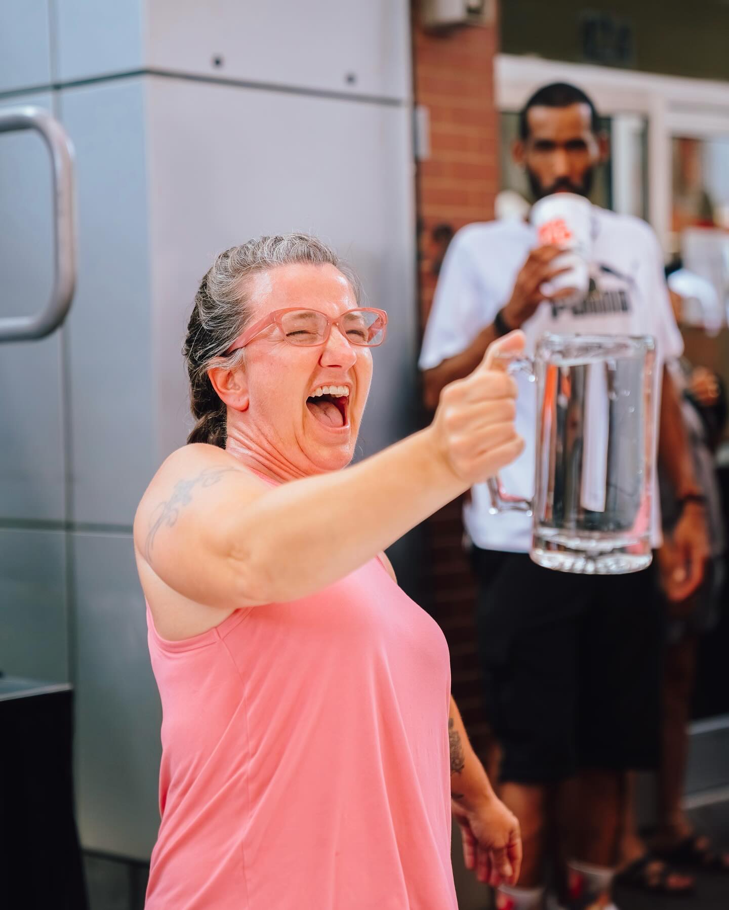 AN image of a woman holding up a stein full of water.