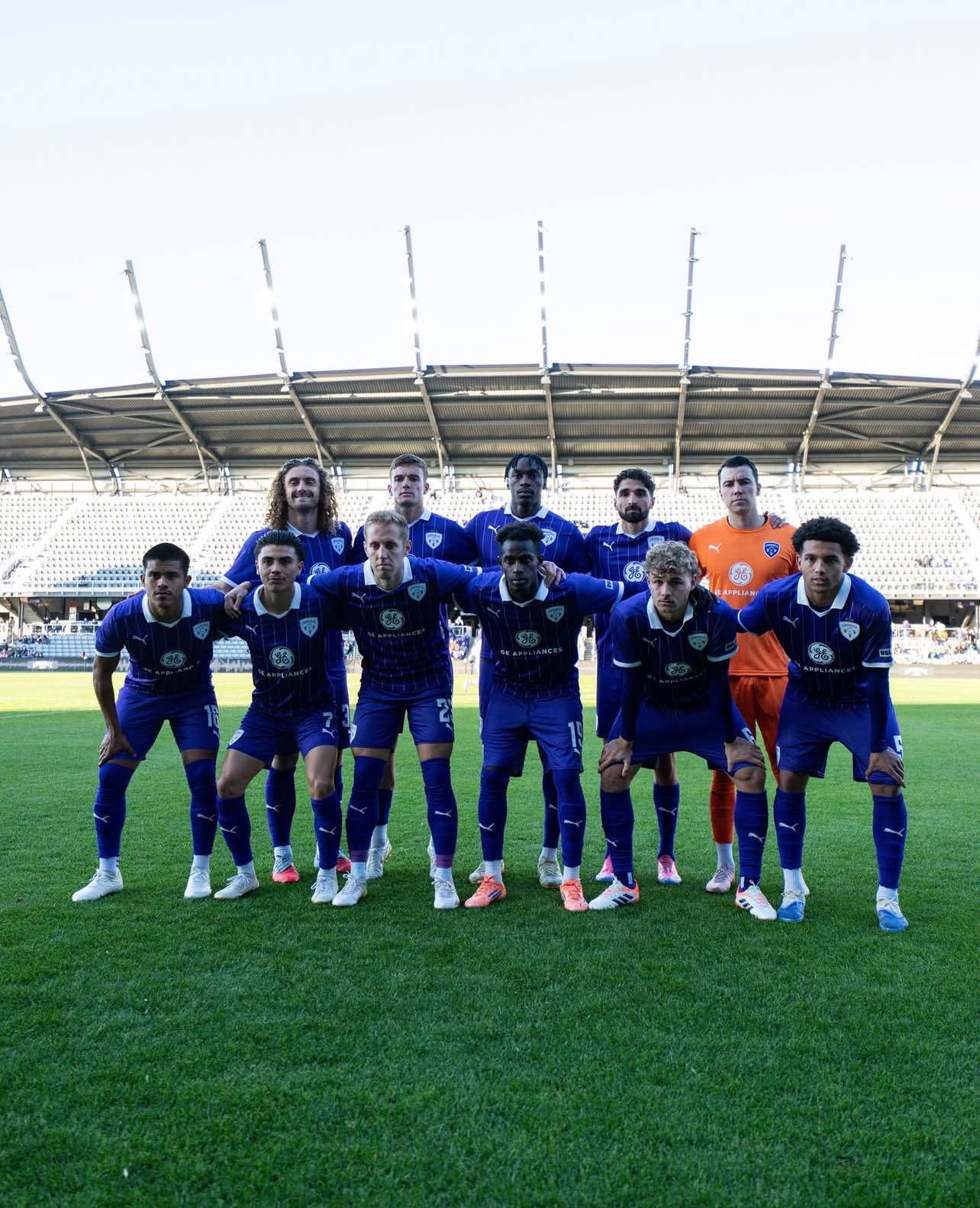 An image of the Lou City soccer players posing for a group photo.
