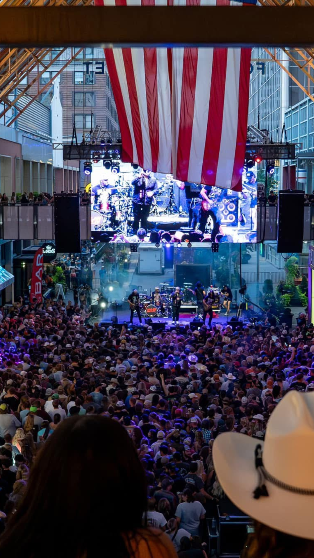 An image of a full crowd at a concert and the view is from the PBR Beer Bridge.