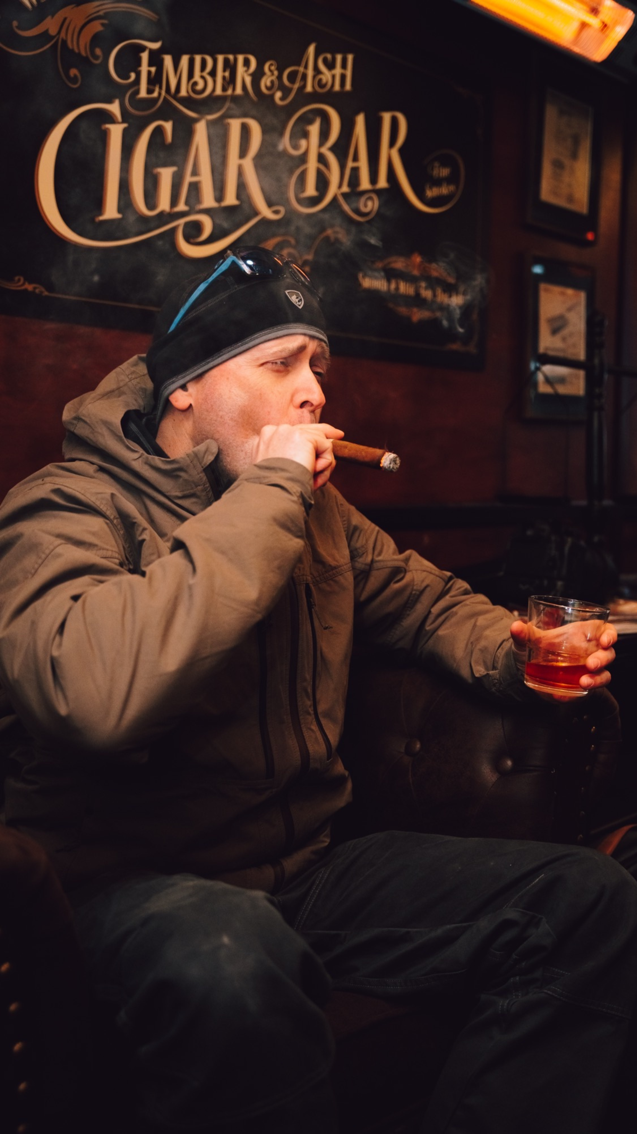 An image of a man smoking a cigar in a mobile cigar lounge.