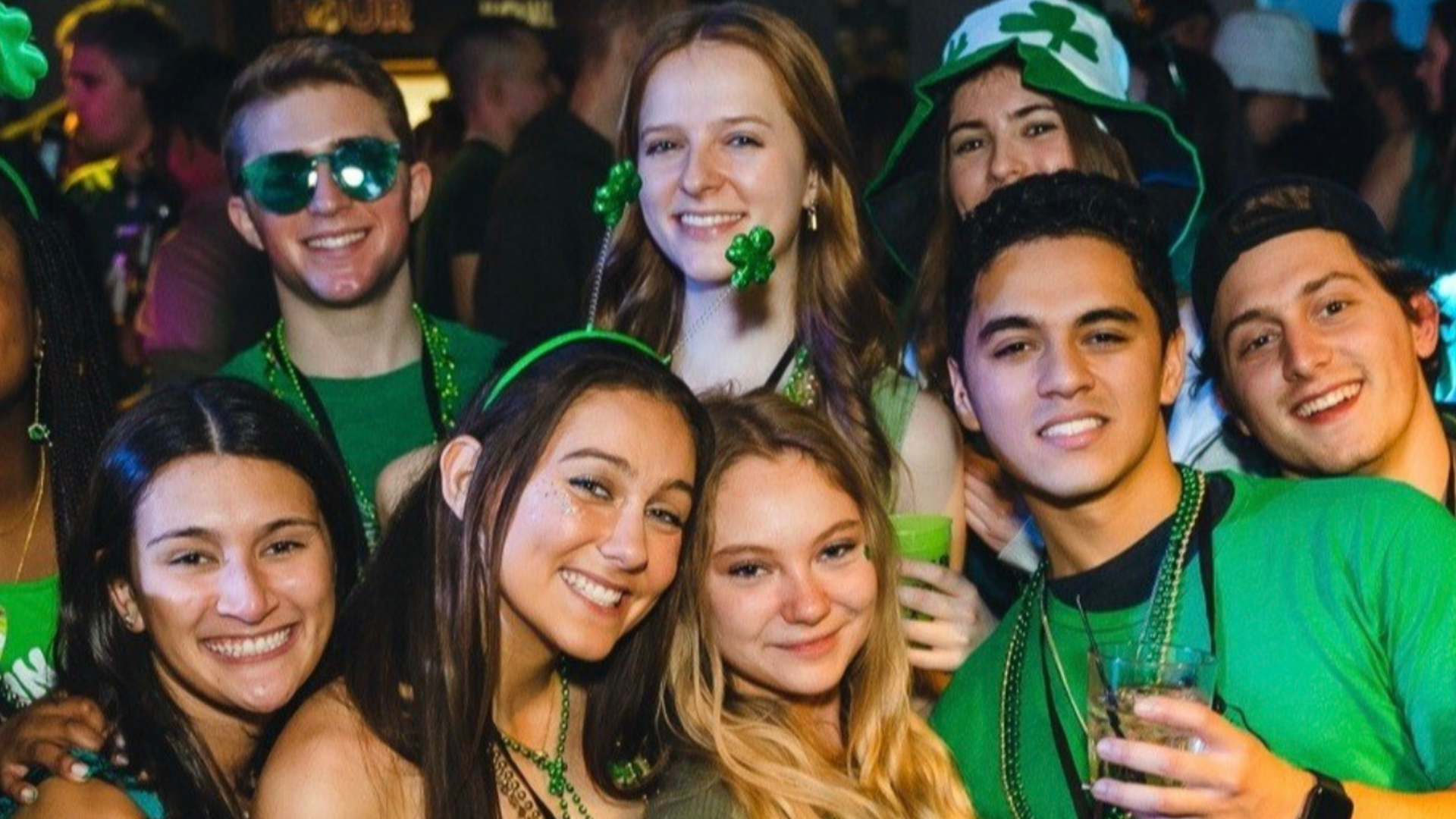 An image of people posing for a picture in St. Paddy's Day clothing.