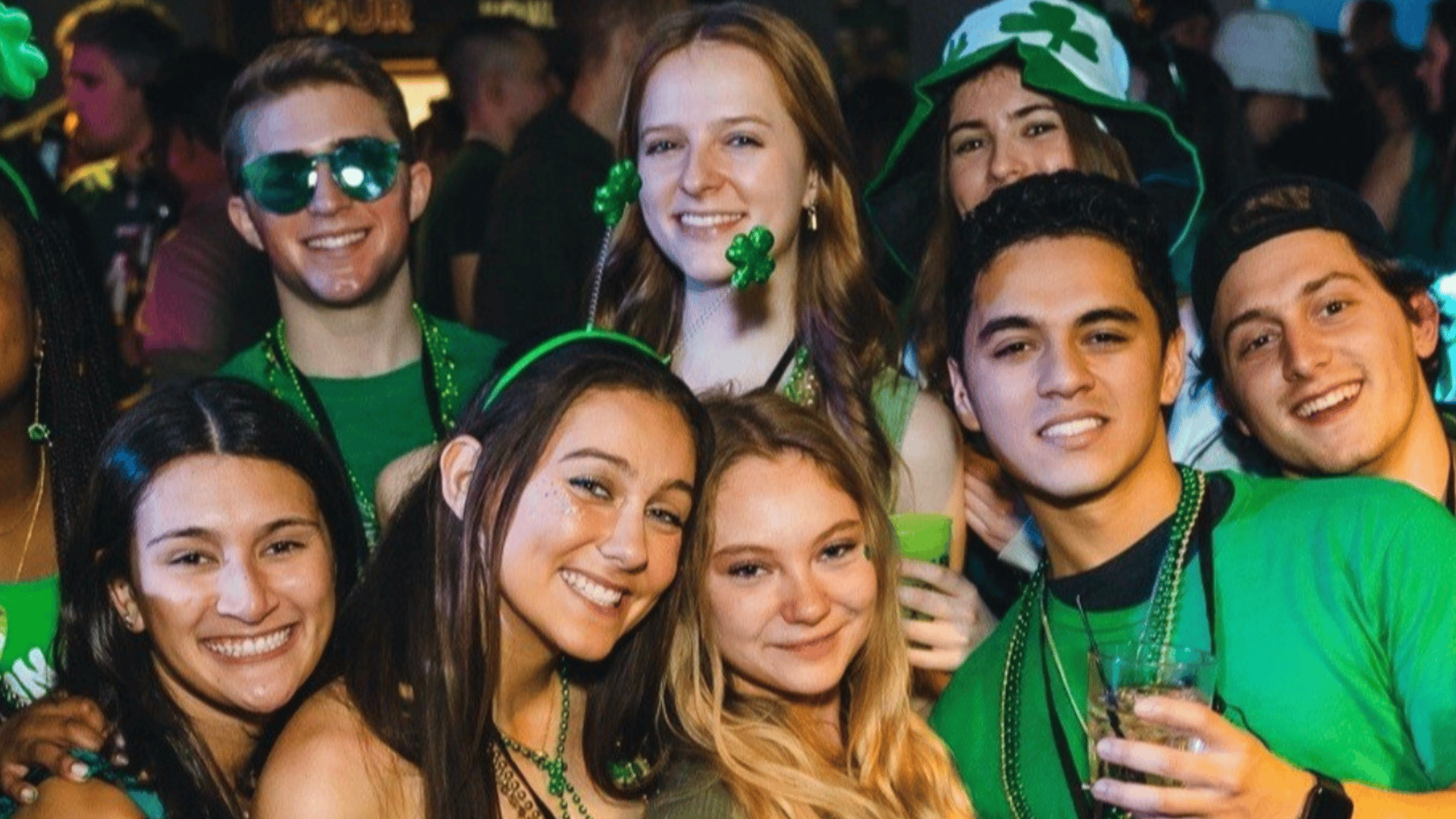 An image of people posing for a picture in St. Paddy's Day clothing.