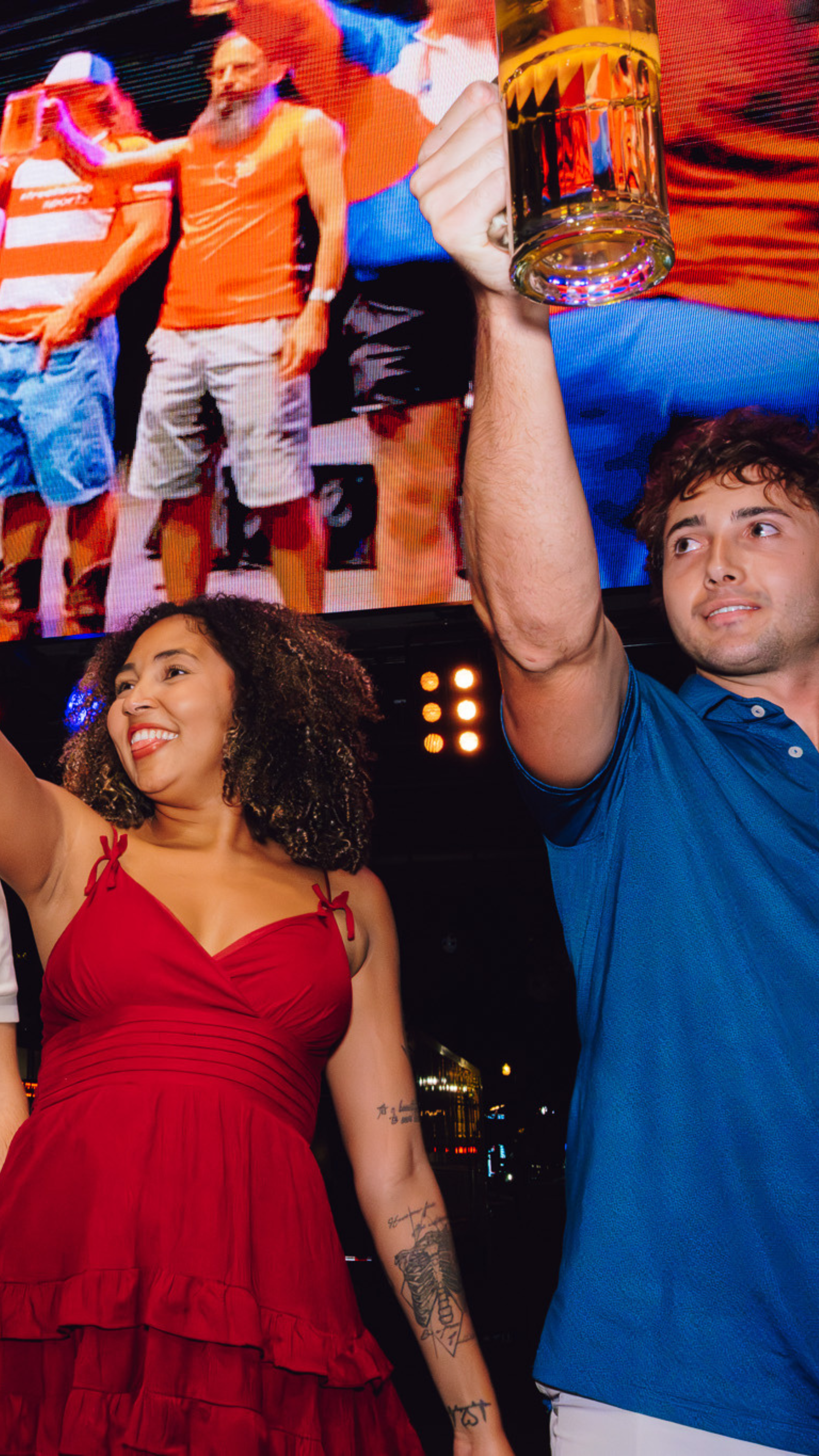 An image of two people holding a stein of beer during a stein holding contest.