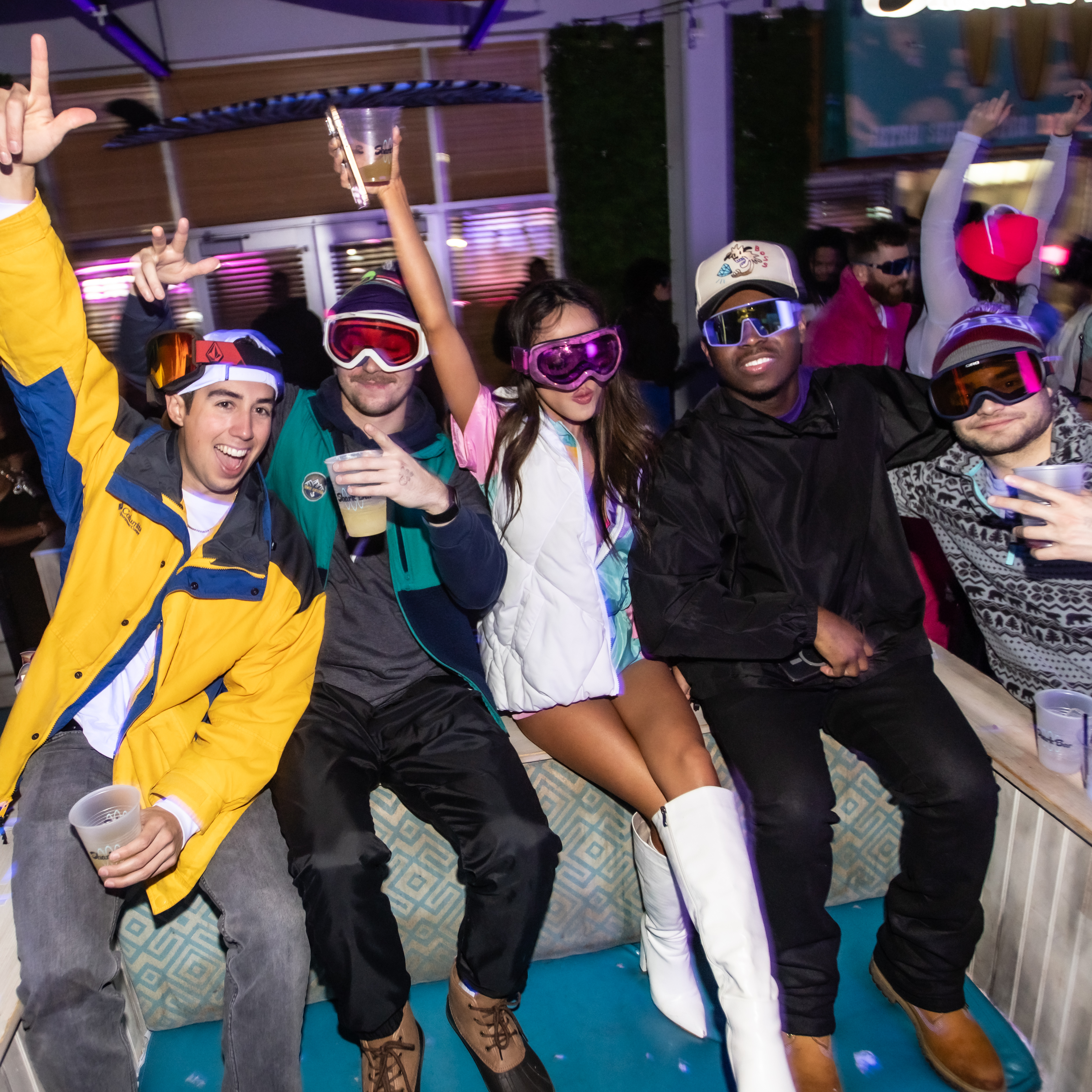 Group wearing ski apparel in VIP Section of Shark Bar