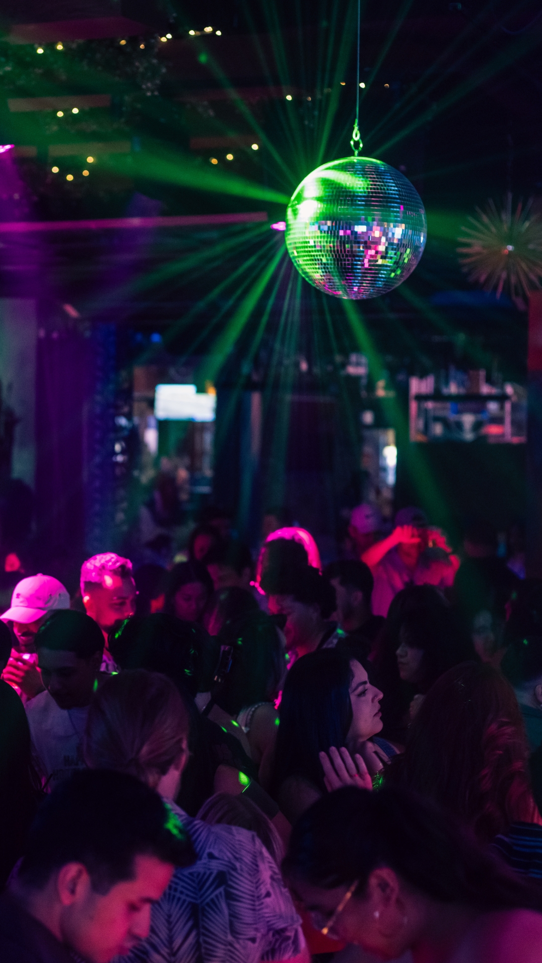 The disco ball shines on the dancefloor at Besos y Abrazos.