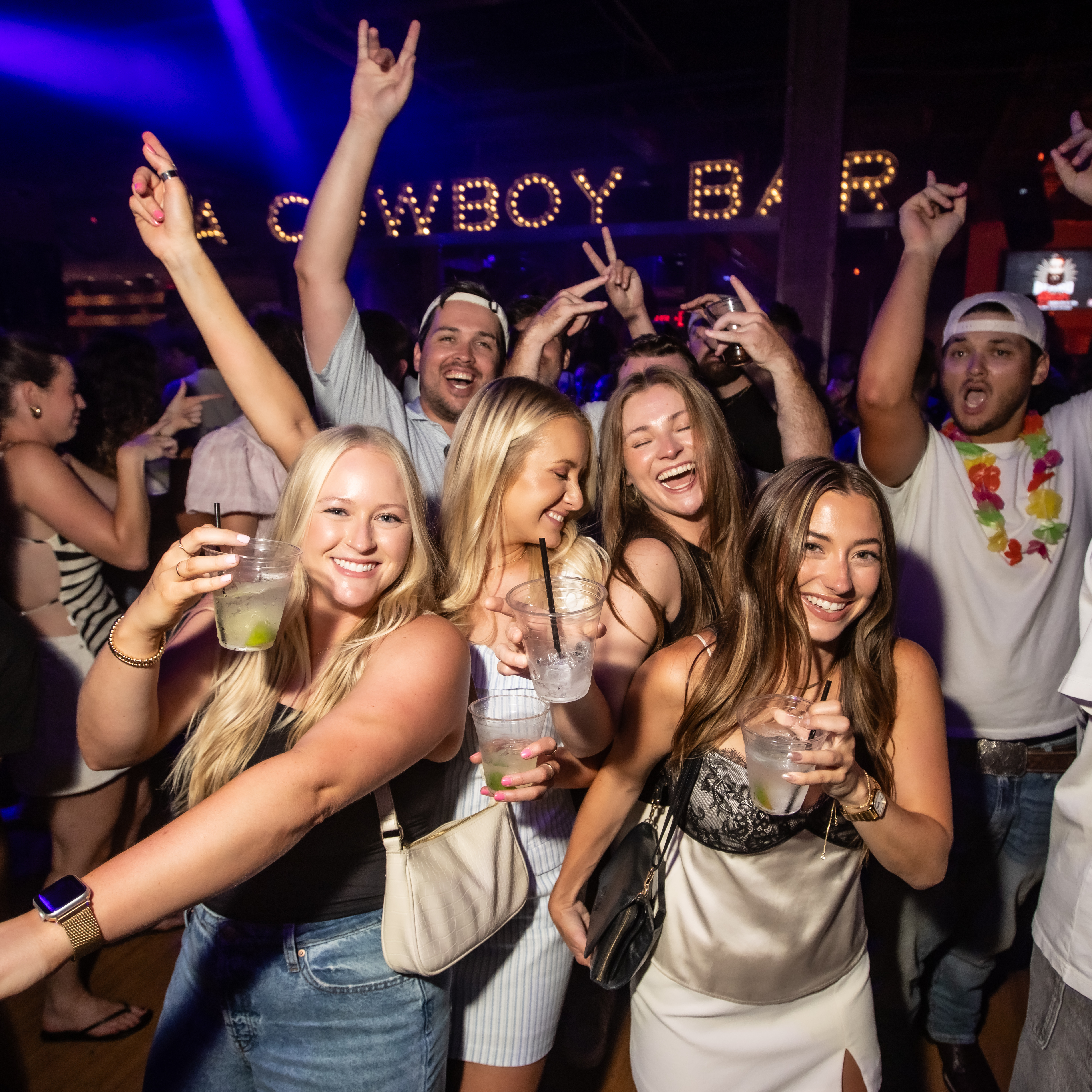 Large group of ladies at PBR with large crowd in background