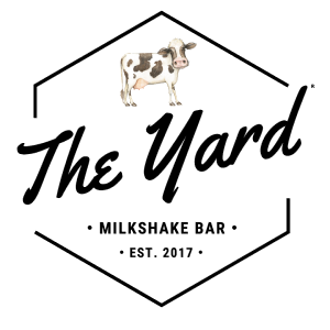 The Yard Milkshake Bar text logo with cartoon cow.