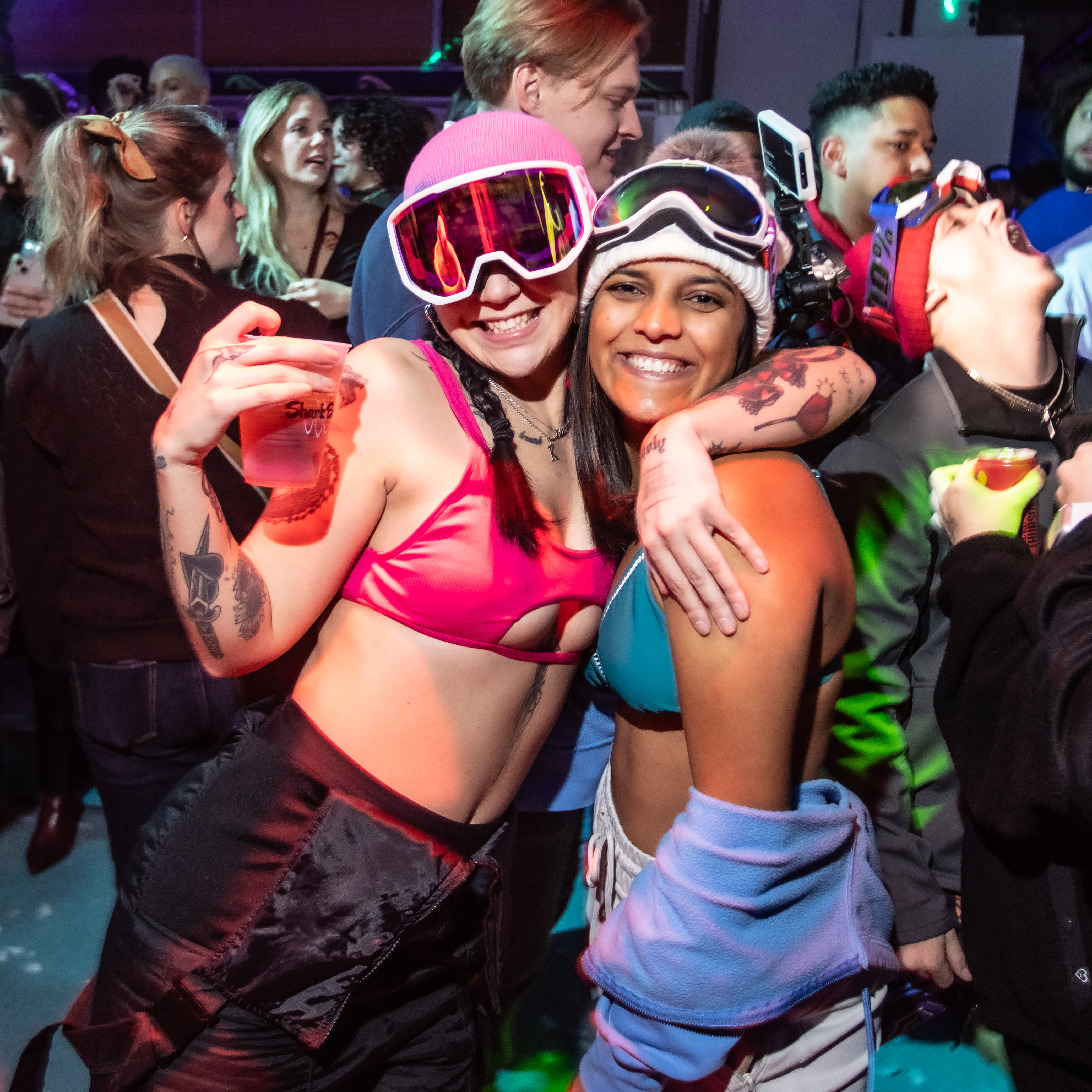 Two girls wearing bikinis and snow gear at Shark Bar