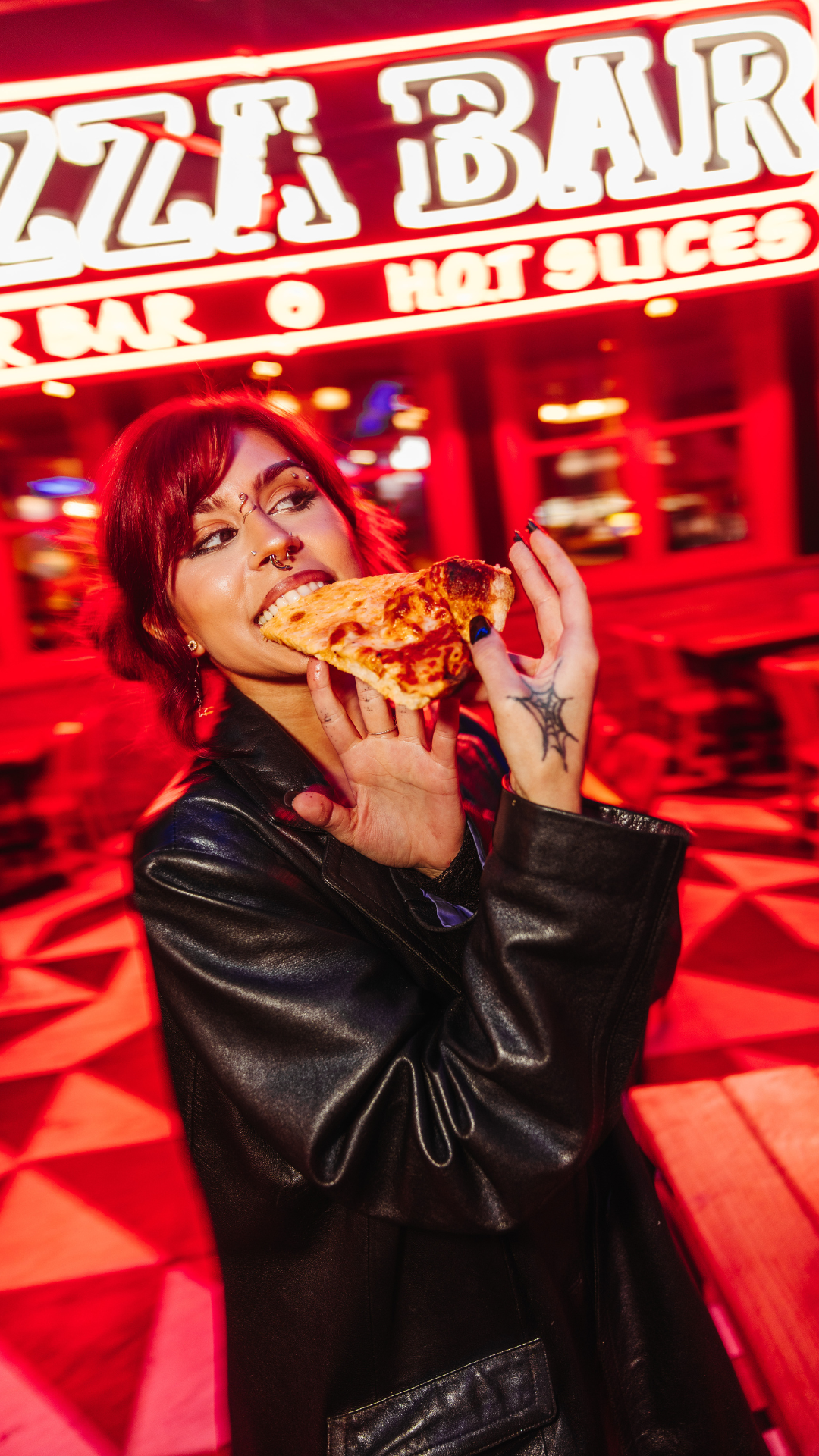 Woman eating pizza at Pizza Bar