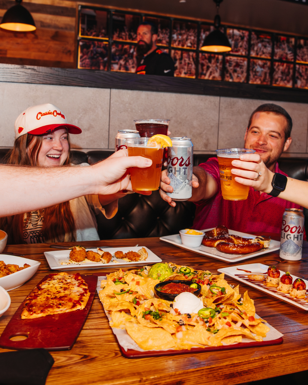 Guests cheering drinks at No Other Pub