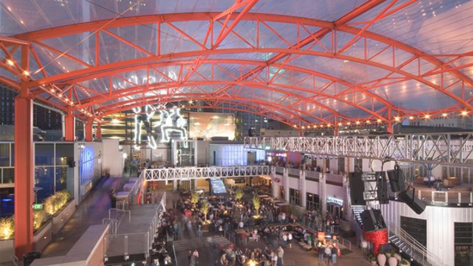 The inside of the venue before an event, highlighting the bright red metal support beams.